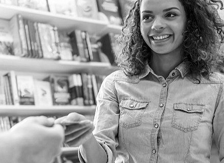 Someone handing a card to a woman